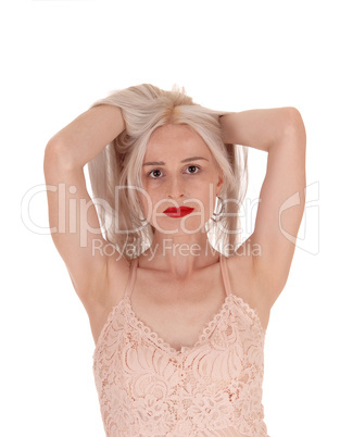 Woman messing up her long blond hair