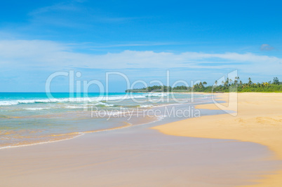 Beautiful ocean, long sandy beach and sky