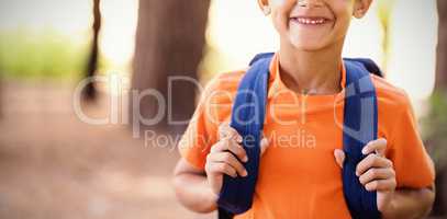 Little boy carrying backpack