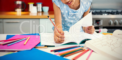 Girl drawing in book