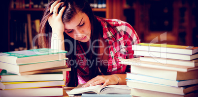 Focused student surrounded by books