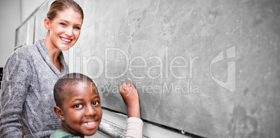 Teacher and student making addition in classroom