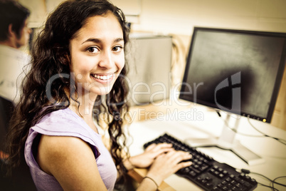 Smiling brunette student with computer Smiling brunette student with computer