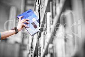 Students hand with smartwatch picking book from bookshelf