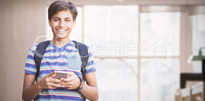 Composite image of portrait of happy boy using phone
