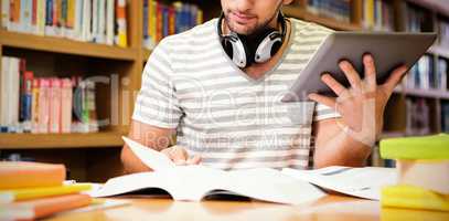 Student studying in library with tablet