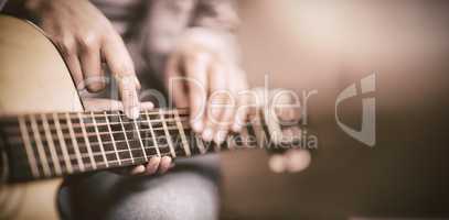 Teacher giving guitar lessons to pupil