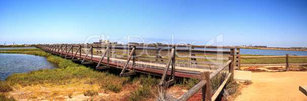 Bridge along the peaceful and tranquil marsh of Bolsa Chica wetl