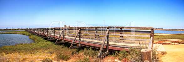 Bridge along the peaceful and tranquil marsh of Bolsa Chica wetl