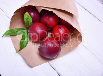 Ripe red peaches in a paper bag