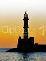 Lighthouse silhouette at sunset.