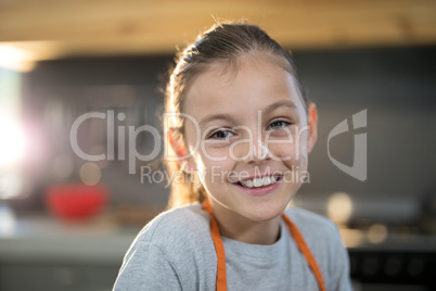 Smiling girl with flour on her nose