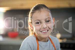 Smiling girl with flour on her nose