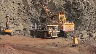 The excavator and dumper in the quarry