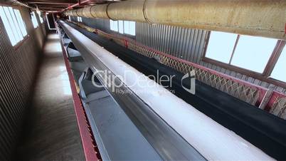Сonveyor belt on factory, Ceramic factory equipment, Transportation of clay on the conveyor, industrial interior, Transportation of raw materials on the conveyor