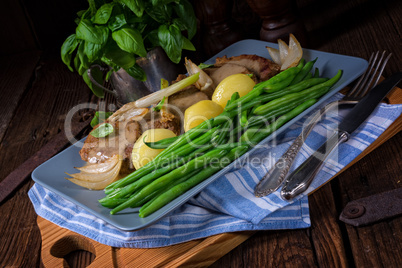 Beef medallions with caramelized beans and young potatoes