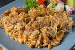 Meat strips in spicy sweet and sour sauce and green salad