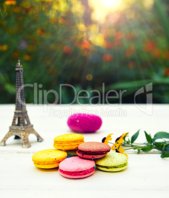 Colored cakes macarons on a white table