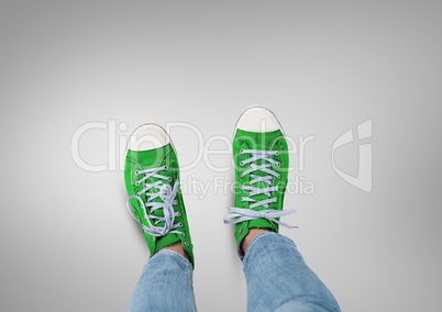 Green shoes on feet with grey background