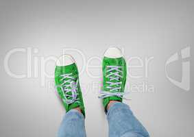 Green shoes on feet with grey background