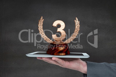 Person holding a tablet with a trophy