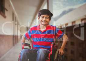 Disabled boy in wheelchair in school corridor