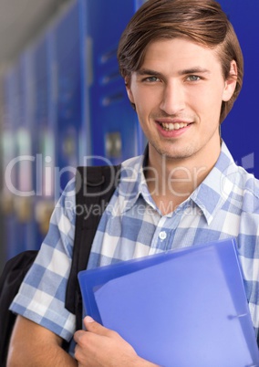 male student holding files in front of lockers