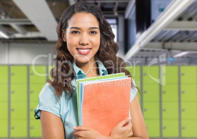 female student holding files in front of lockers