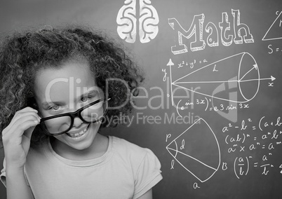 Girl pointing at math equations on blackboard