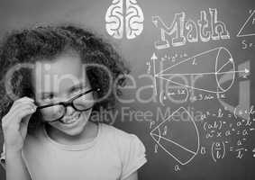 Girl pointing at math equations on blackboard
