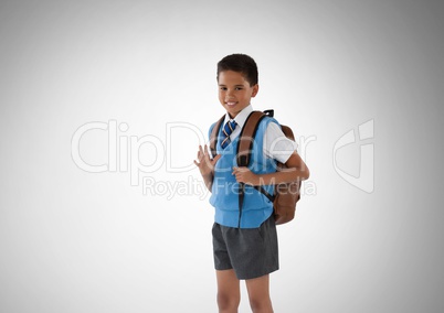 Schoolboy in front of grey background