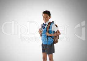 Schoolboy in front of grey background