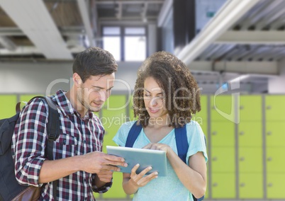 students holding tablet in front of lockers