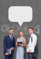 Happy business people with speech bubble holding devices against grey background