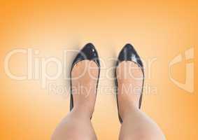 Black shoes on feet with yellow background