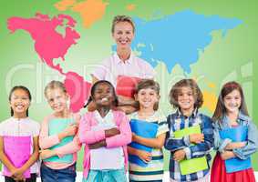 Kids holding school books with teacher in front of colorful world map