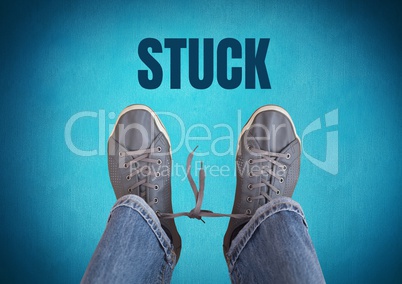 Stuck text and  and grey shoes on feet with blue background