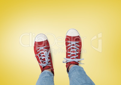 Red shoes on feet with yellow background