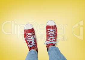 Red shoes on feet with yellow background