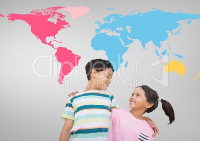 Kids hugging in front of colorful world map