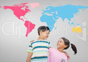Kids hugging in front of colorful world map