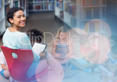 Elementary school teacher with class in library