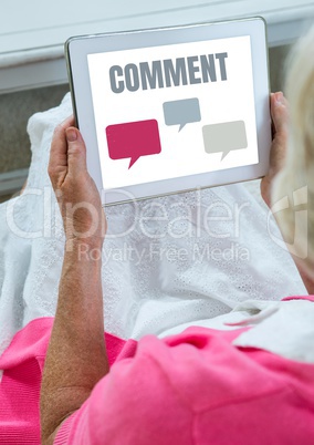 Comment text and chat graphic on tablet screen with hands of old woman