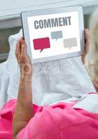 Comment text and chat graphic on tablet screen with hands of old woman