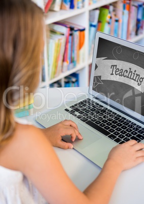 Girl using a computer with school icon on screen
