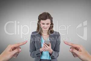 Hands pointing at happy business woman using her phone against grey background