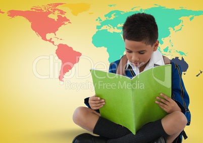 Schoolboy reading in front of colorful world map