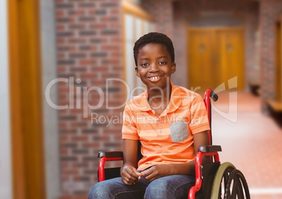 Disabled boy in wheelchair in school corridor