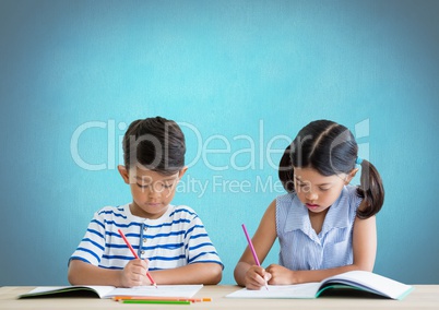 School kids writing at desk in front of blue background