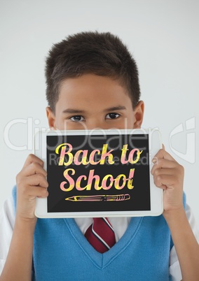 Boy holding a tablet with back to school text on screen